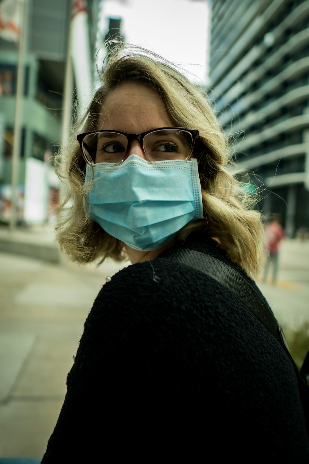 woman in black coat wearing eyeglasses