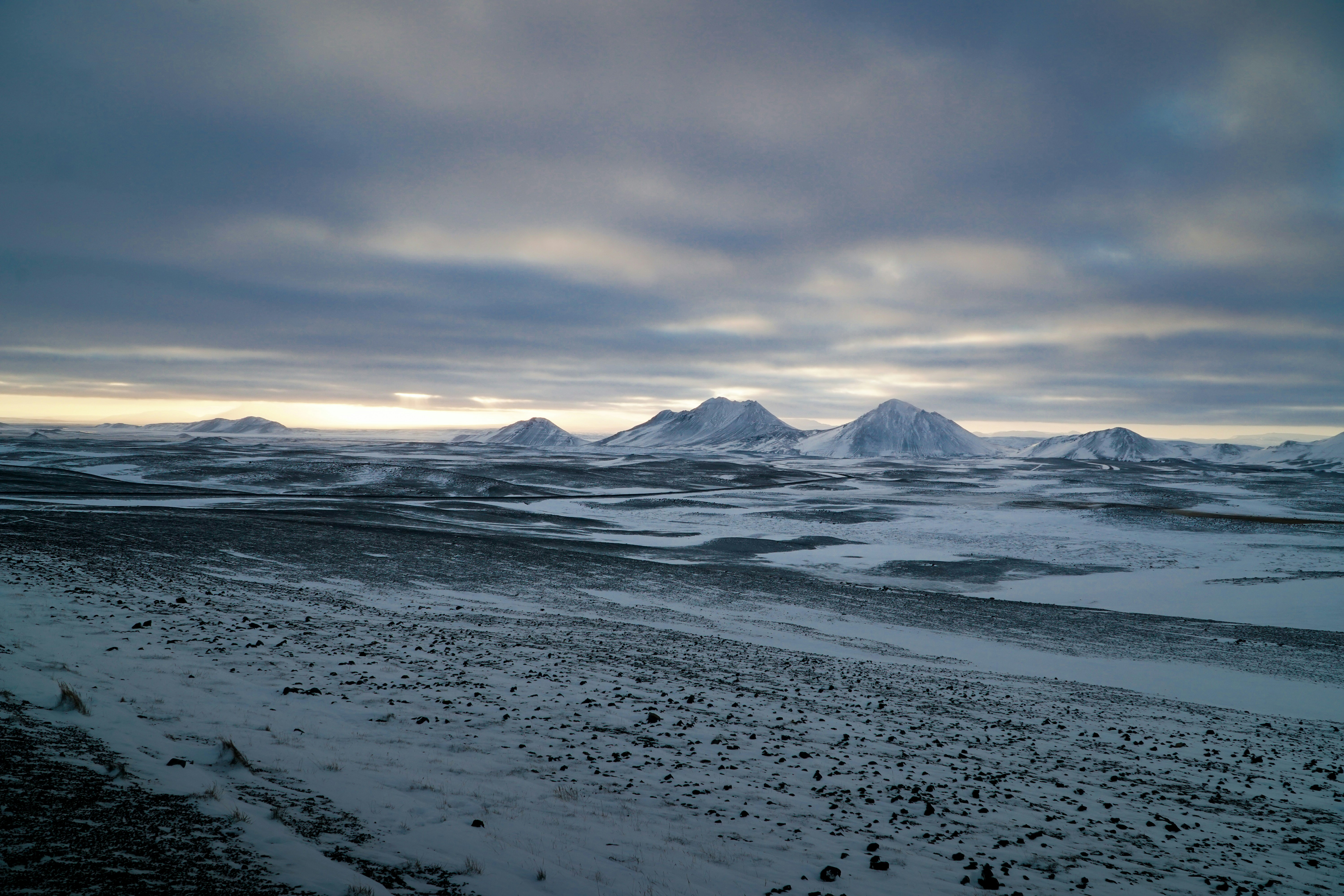 snow covered mountain under cloudy sky during daytime