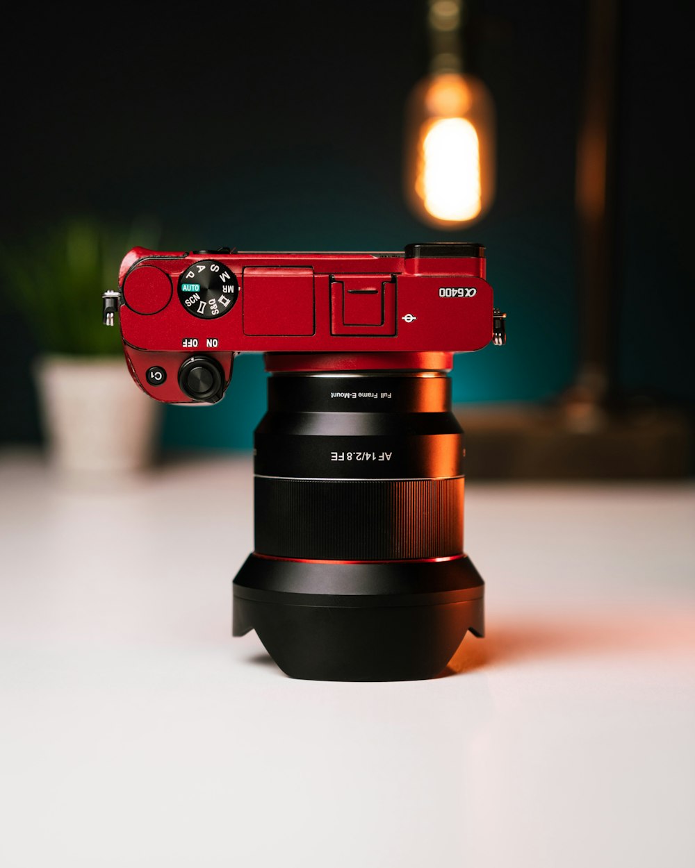 red and black camera on white table
