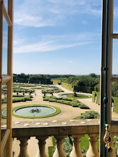 Magical view from the open window overlooking the royal gardens of the Palace of Versailles.