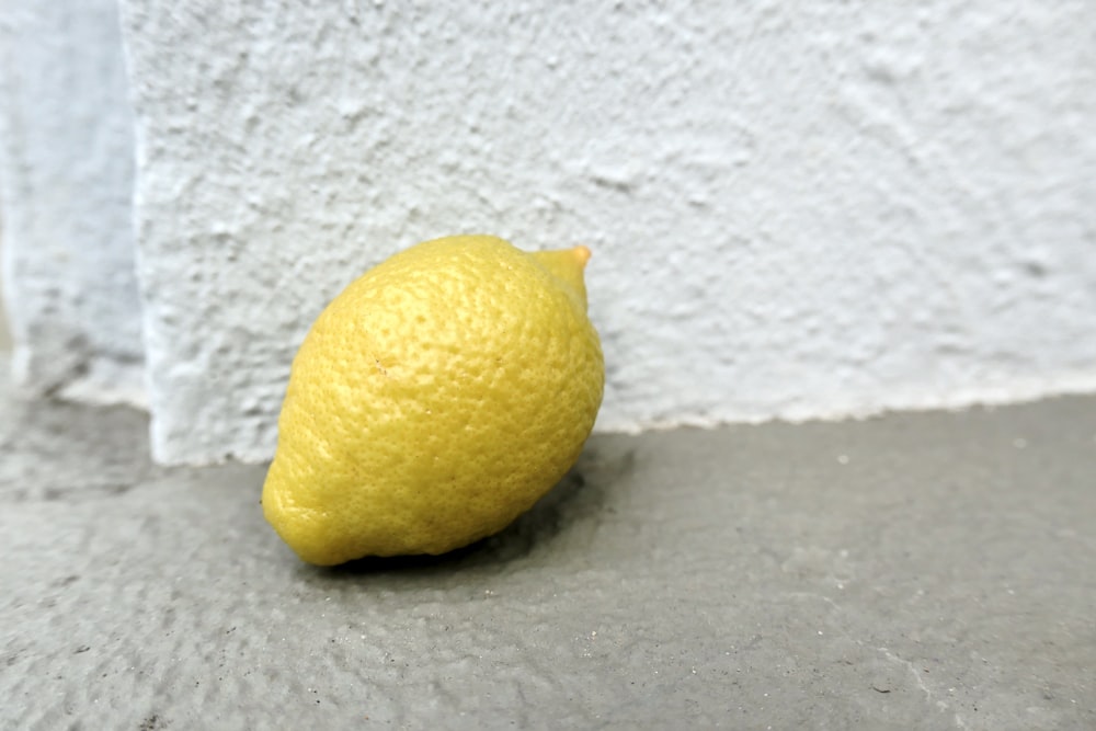 yellow lemon fruit on white surface