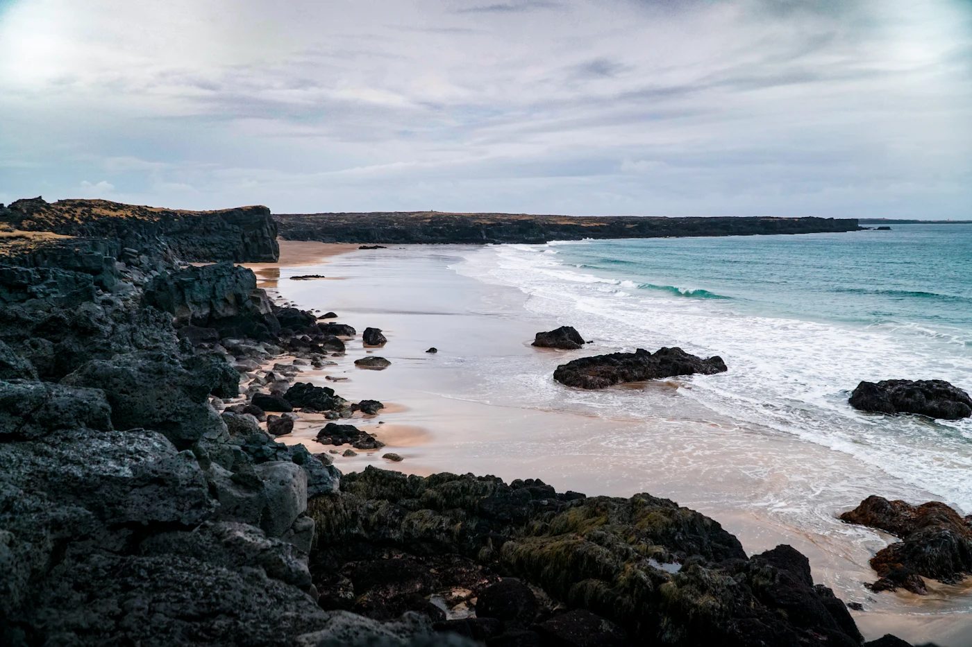 Dark lava rocks and beach on the Snaefellsnes Peninsula coast, Iceland