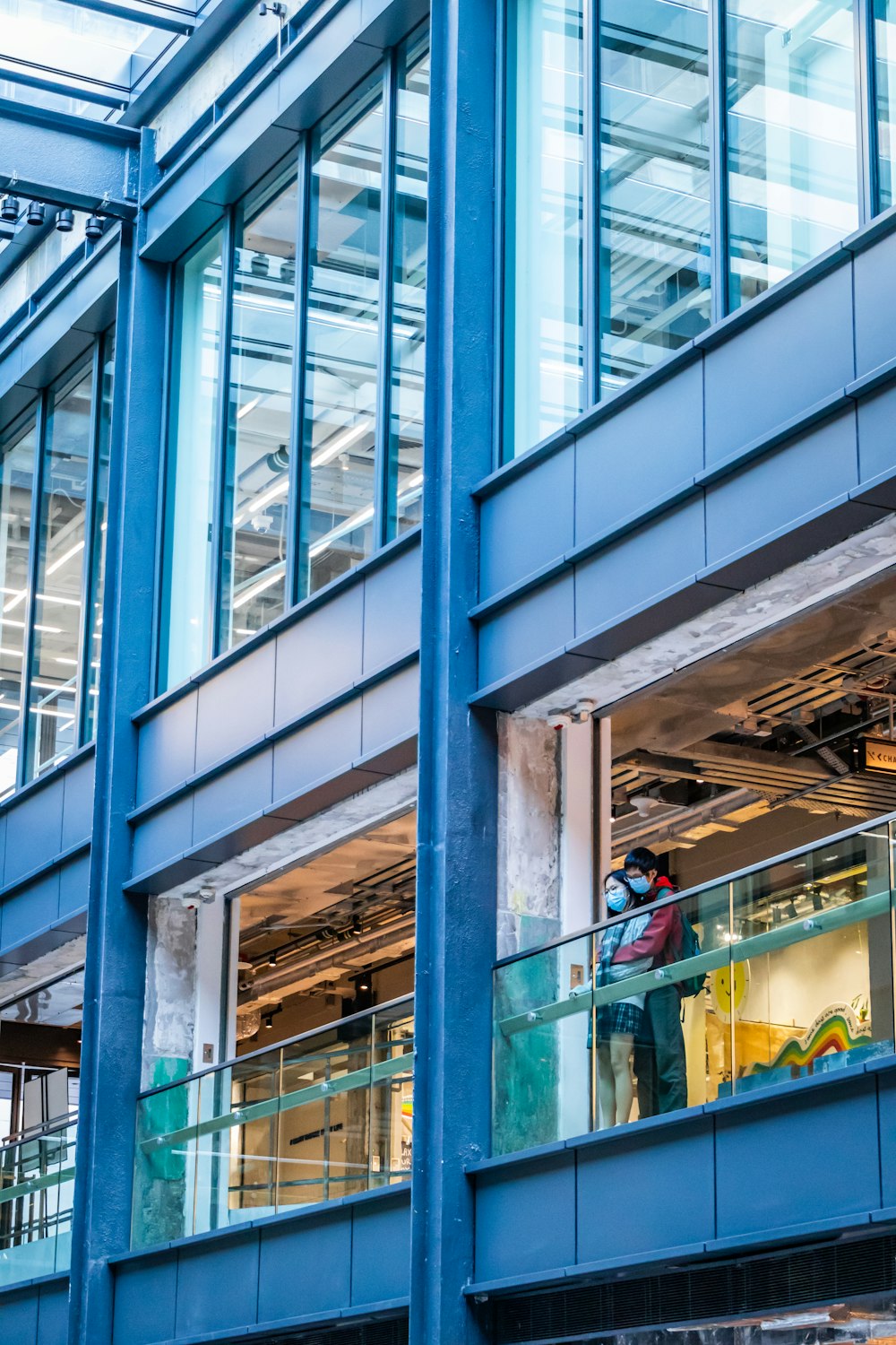 a person standing on a balcony in front of a building