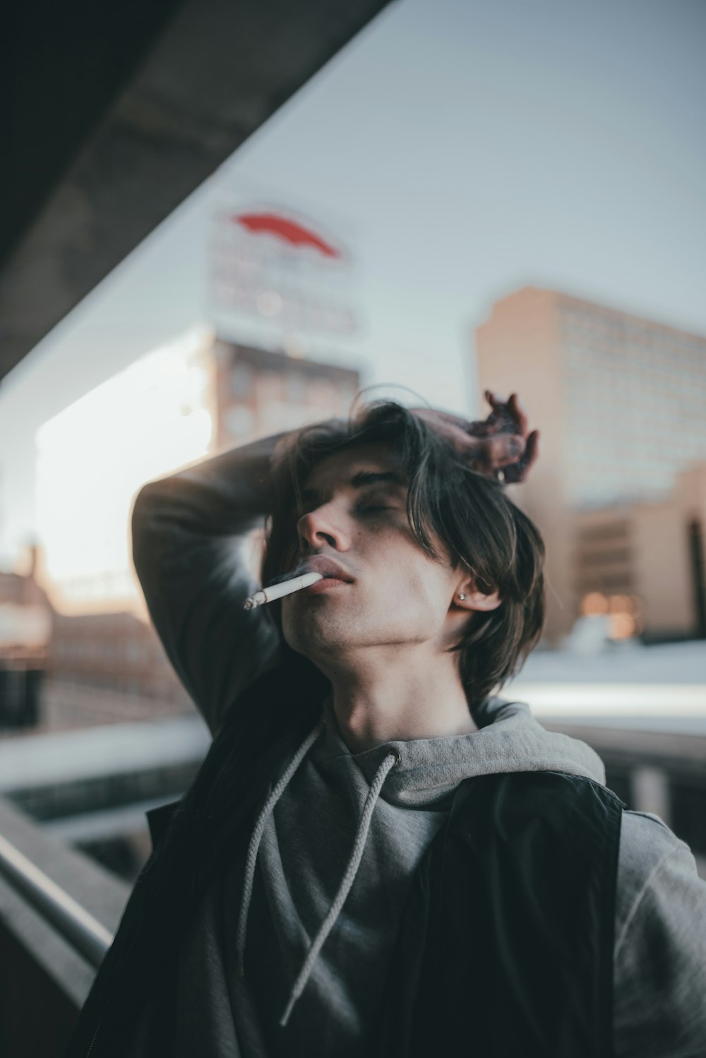 woman in black jacket smoking cigarette
