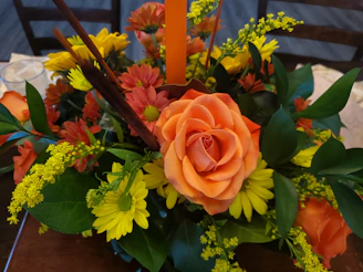Festive centerpiece featuring bold red and orange blooms for celebrations.