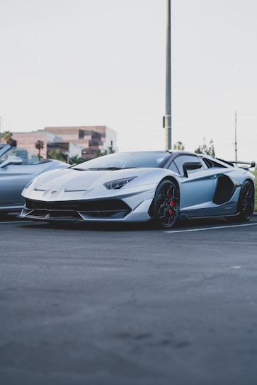 A sleek, shiny car parked in front of a modern home under a clear blue sky.