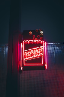 A vibrant still from a queer movie night, featuring colorful popcorn and a glowing TV screen.