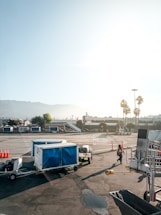 A friendly taxi driver helping a passenger with luggage at Arica airport