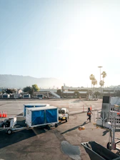 Friendly driver assisting a passenger with luggage near Alicante airport.
