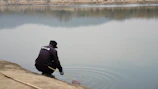 Team members inspecting water quality at Bauer Lakes with testing equipment.
