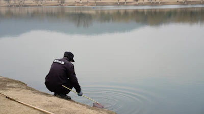 Team members inspecting water quality at Bauer Lakes with testing equipment.