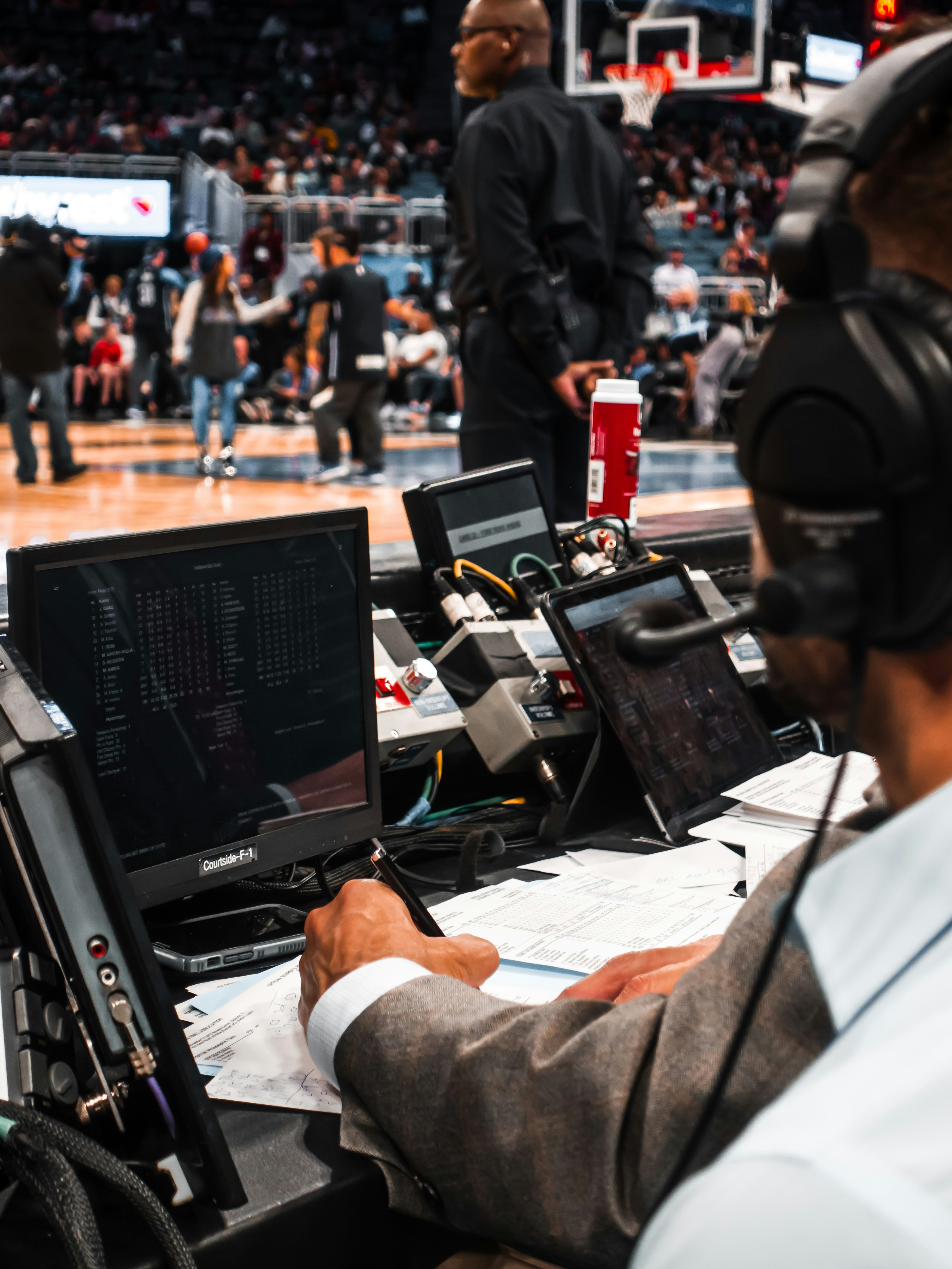 Analysts for an NBA-game at Amway Center in Orlando, Florida writing down statistics.