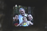 A family portrait taken in a natural outdoor setting.