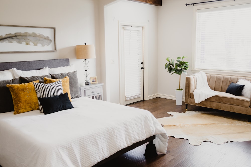 white bed linen near white wooden door