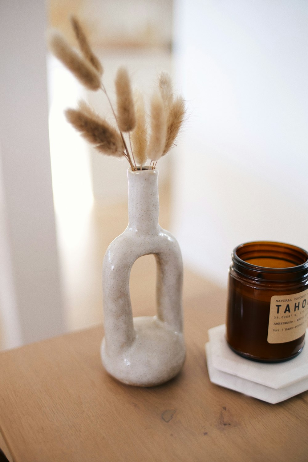 white ceramic figurine on brown wooden table