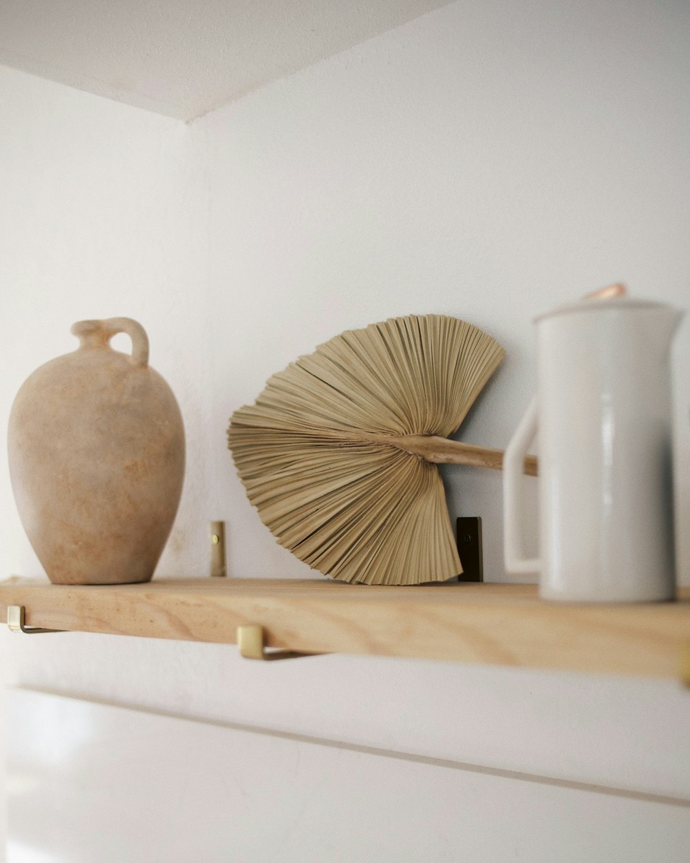 brown wooden table decor on white wooden shelf