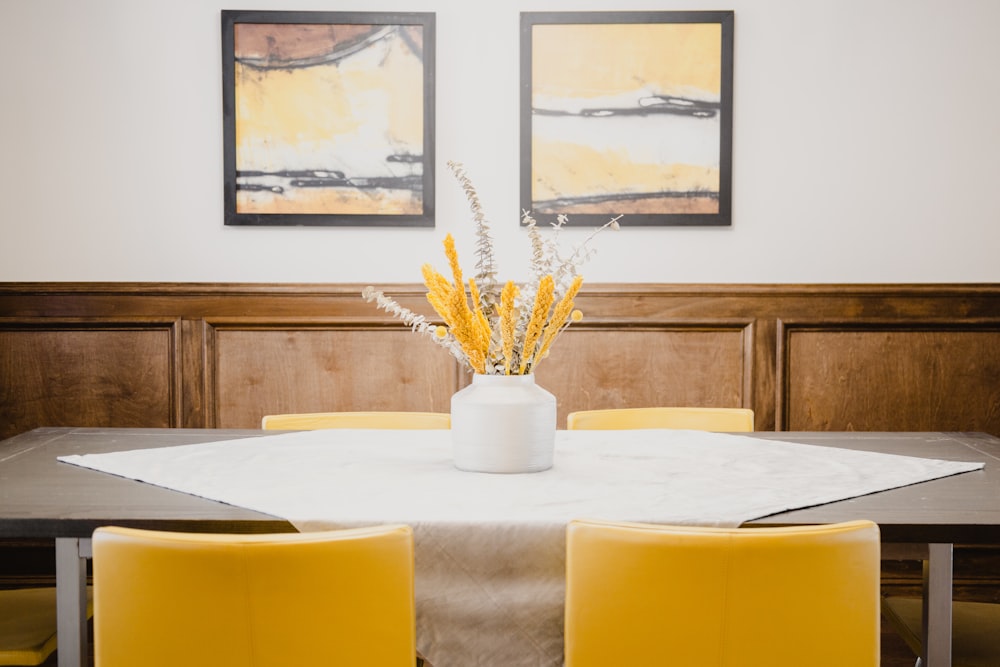 yellow and white flower on white ceramic vase on table