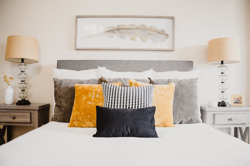 black and white throw pillows on white bed