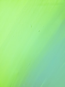 green painted wall with hole