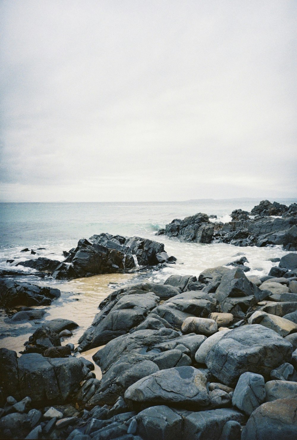 gray rocky shore under gray sky