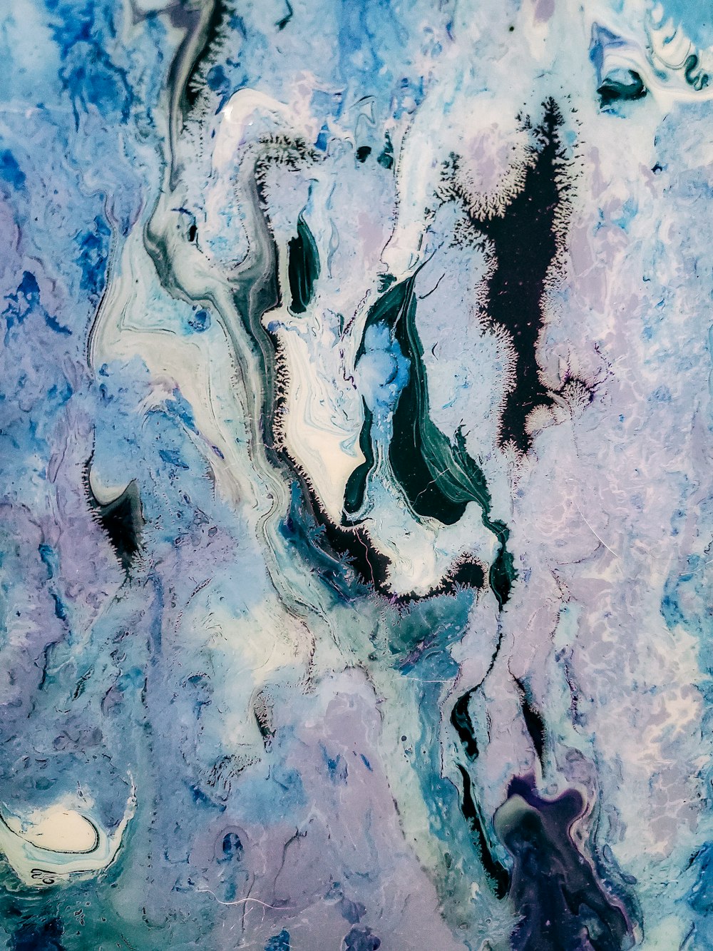 an abstract painting of blue and purple colors