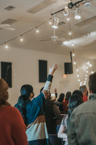 A happy group of people celebrating in a stylish event space with warm lighting.