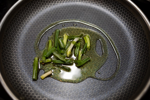 Green vegetable on stainless steel round plate