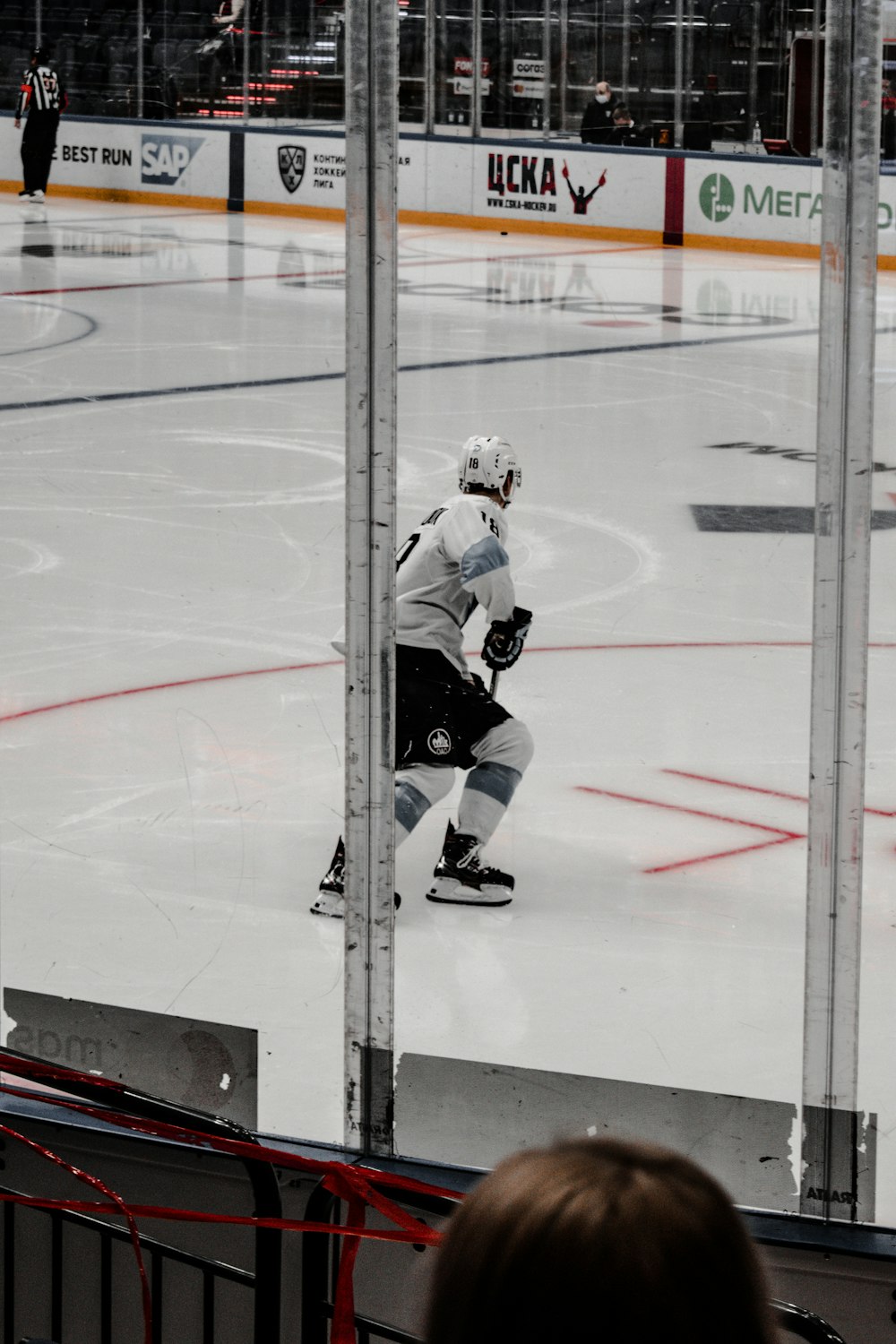 man in white ice hockey jersey playing hockey