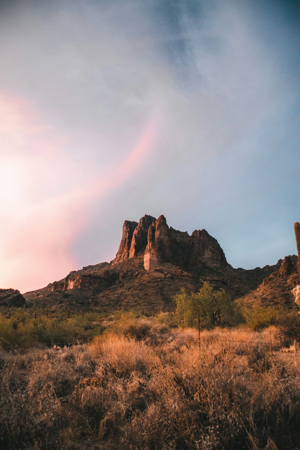 brown rock formation under white clouds