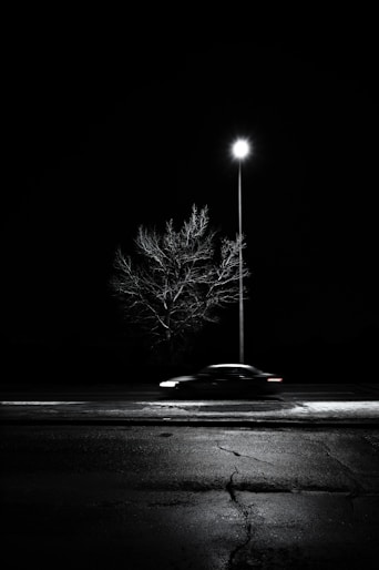 black car on road during night time