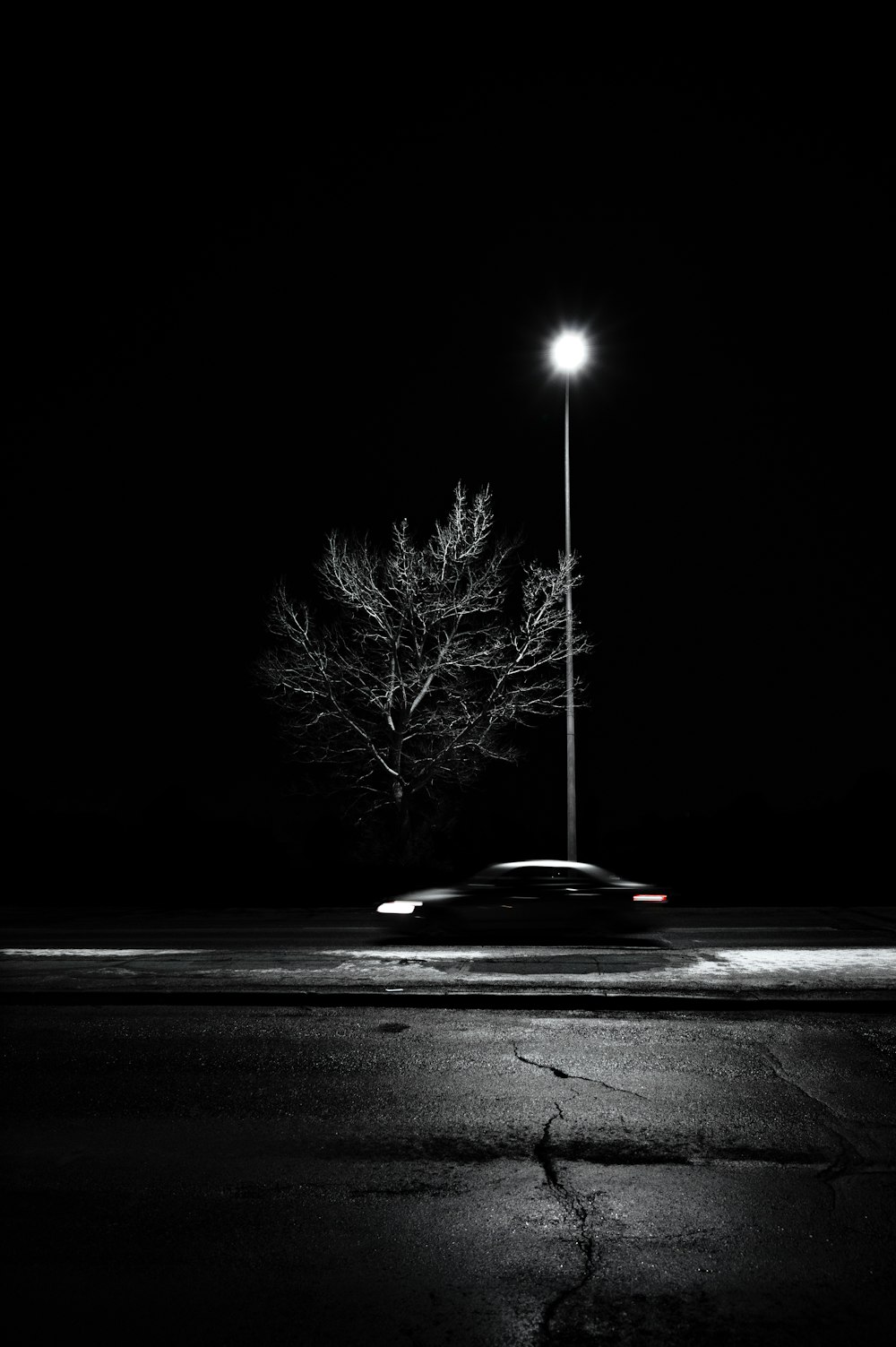 black car on road during night time