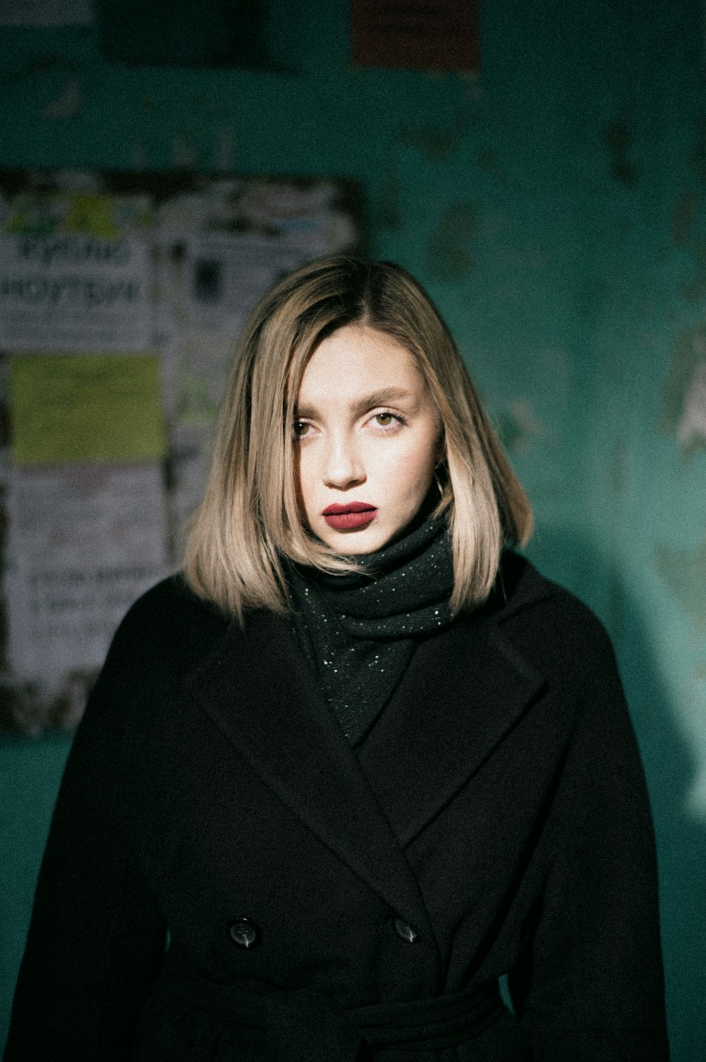 woman in black coat standing