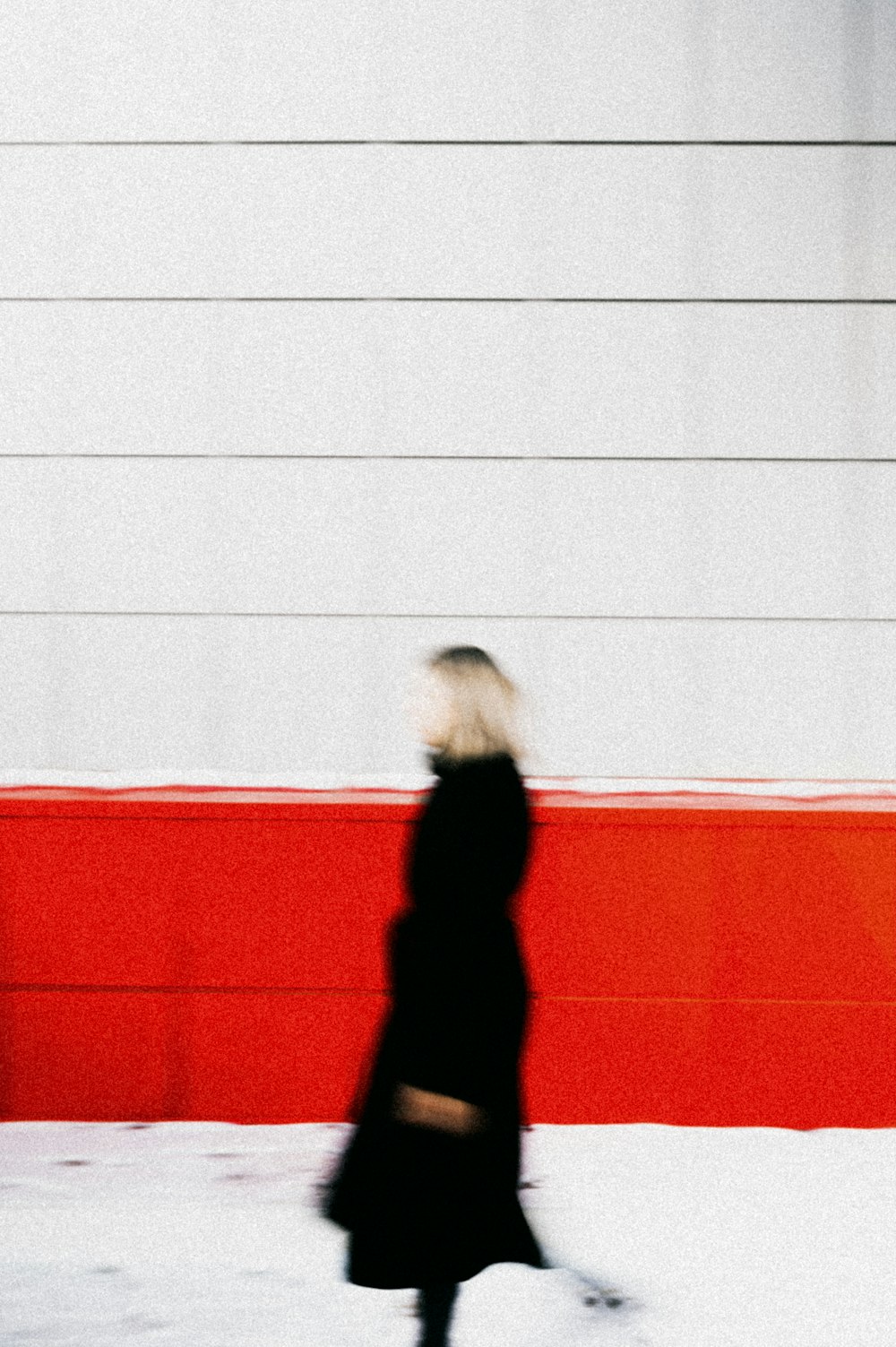 woman in black long sleeve shirt and black pants standing on red and white floor tiles