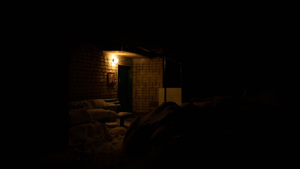 brown brick building with light turned on during night time