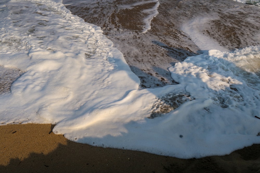 white snow on brown sand