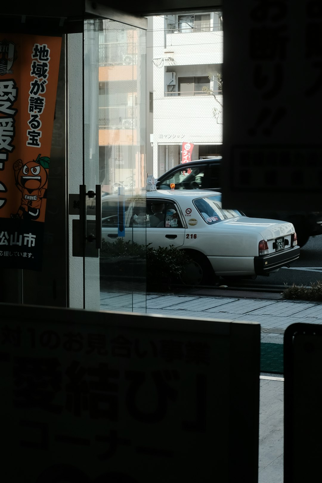 white sedan parked beside store during night time