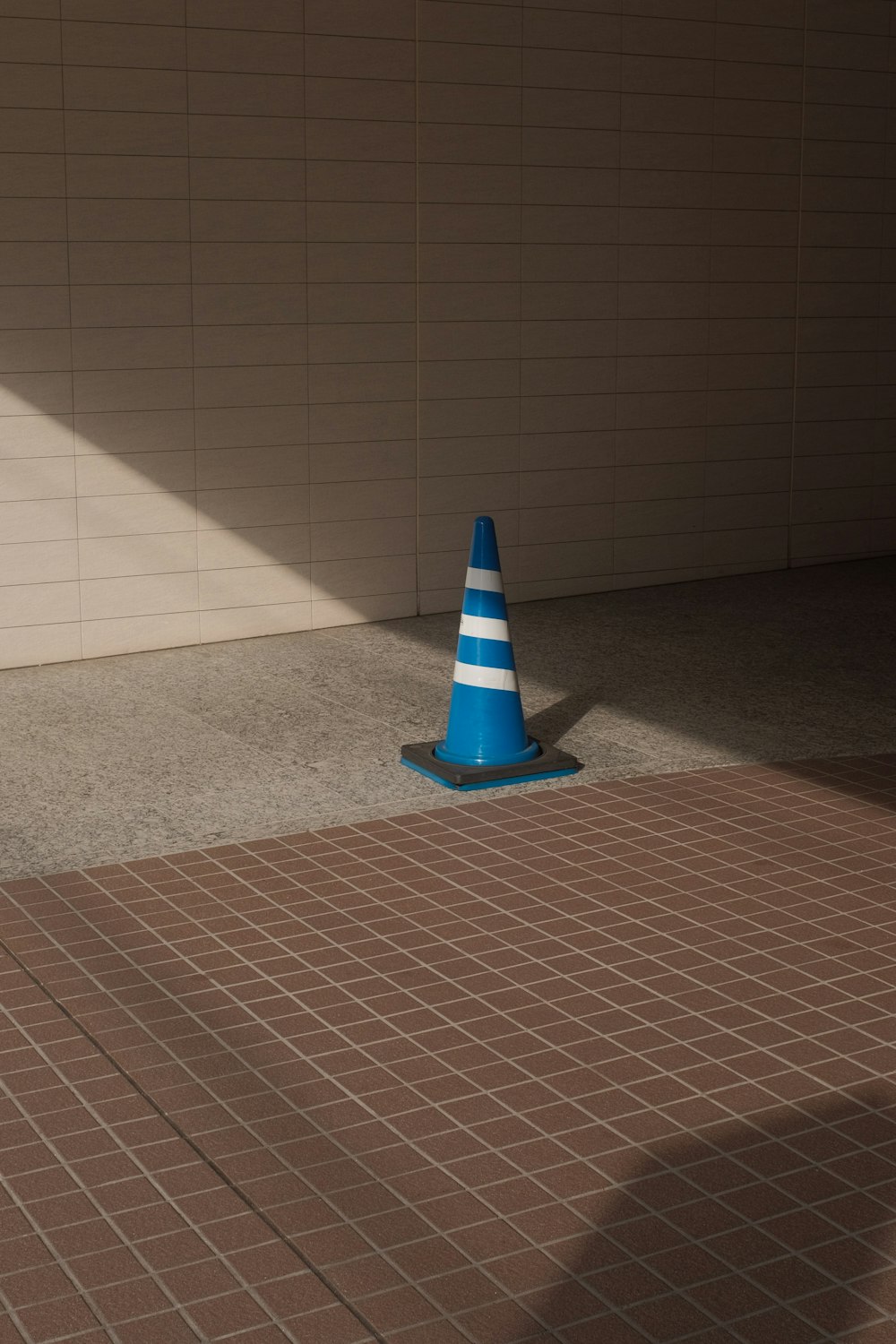 blue and white cone on brown floor