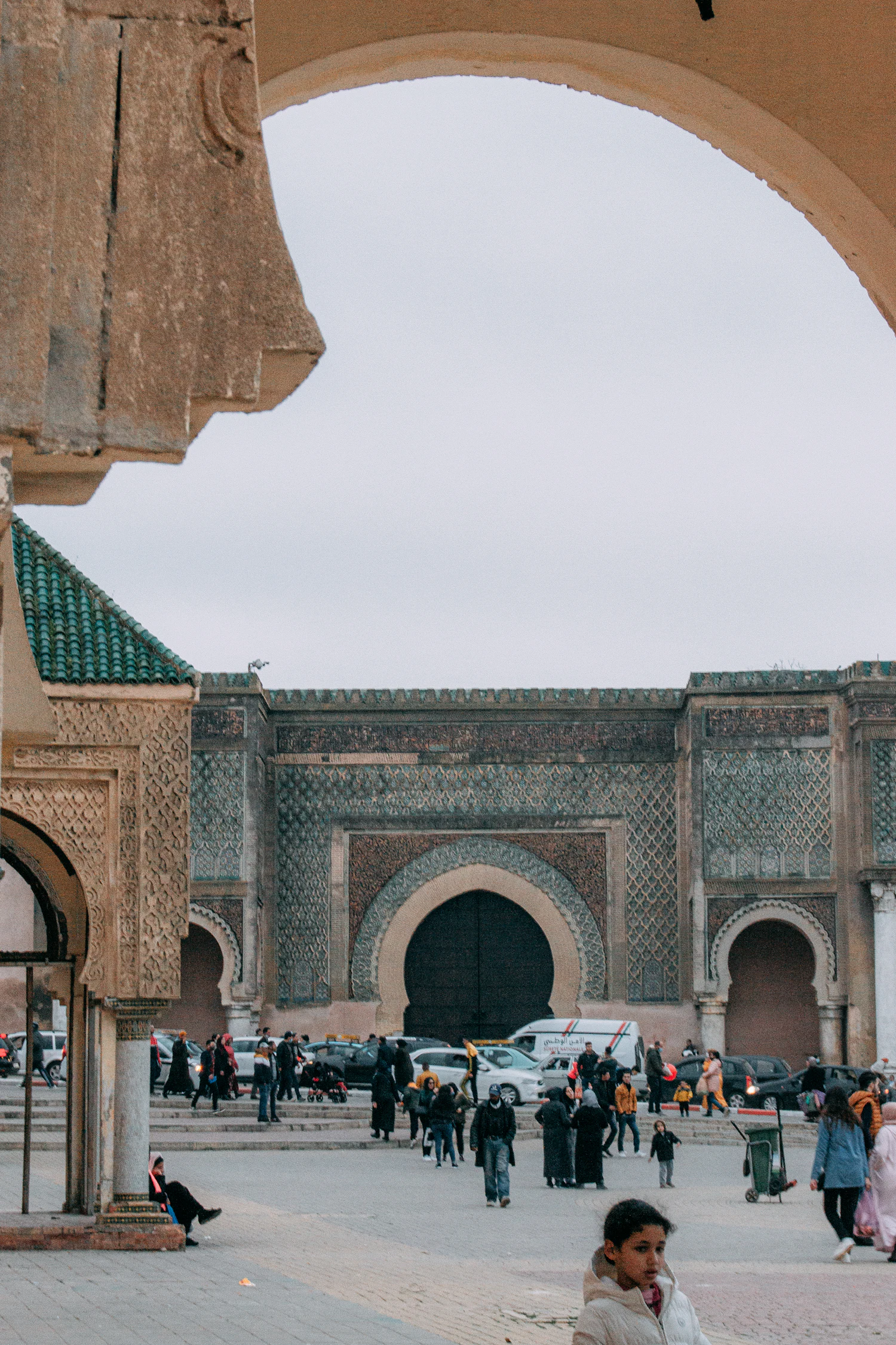 The monumental Bab Mansour gate in Meknes seen through an arch