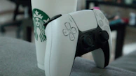 A steaming cup of coffee beside a game controller, inviting players to relax and recharge.