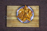 A plate of crispy, golden snacks perfect for sharing on a sunny afternoon.