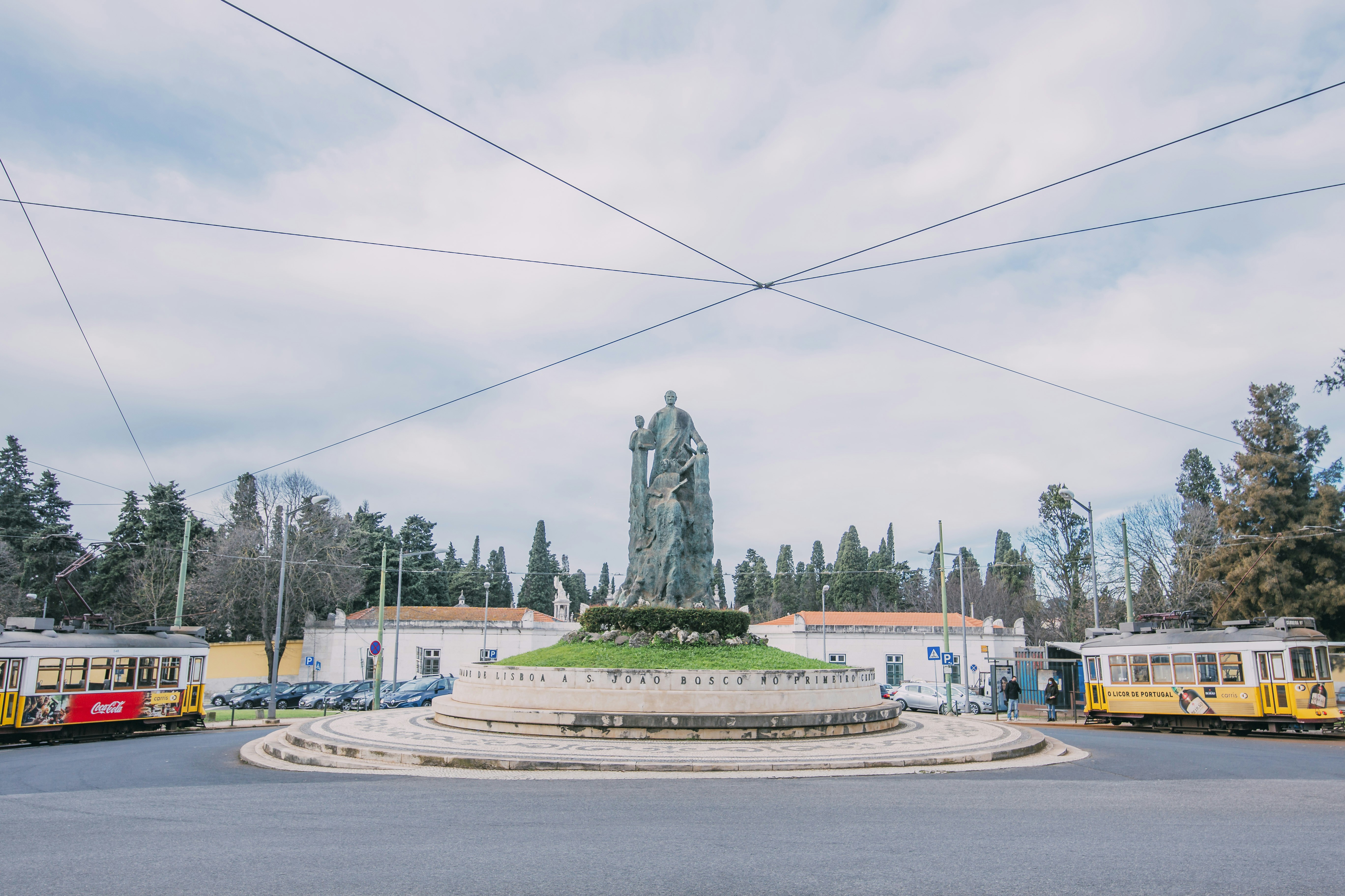 gray concrete statue on gray concrete road during daytime