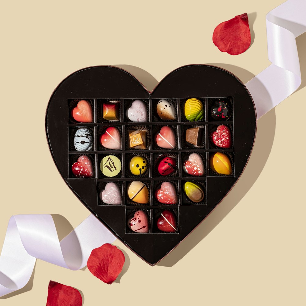 red heart shaped and yellow and red heart shaped candies in box