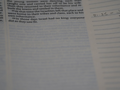 A close-up view of a page from a Bible, with highlighted text from the book of Judges. Some handwritten notes and markings are visible along the margins.