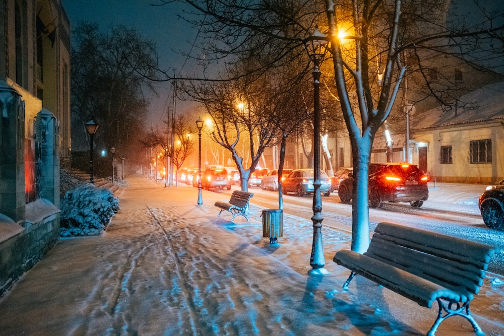 brown wooden bench on snow covered ground during night time