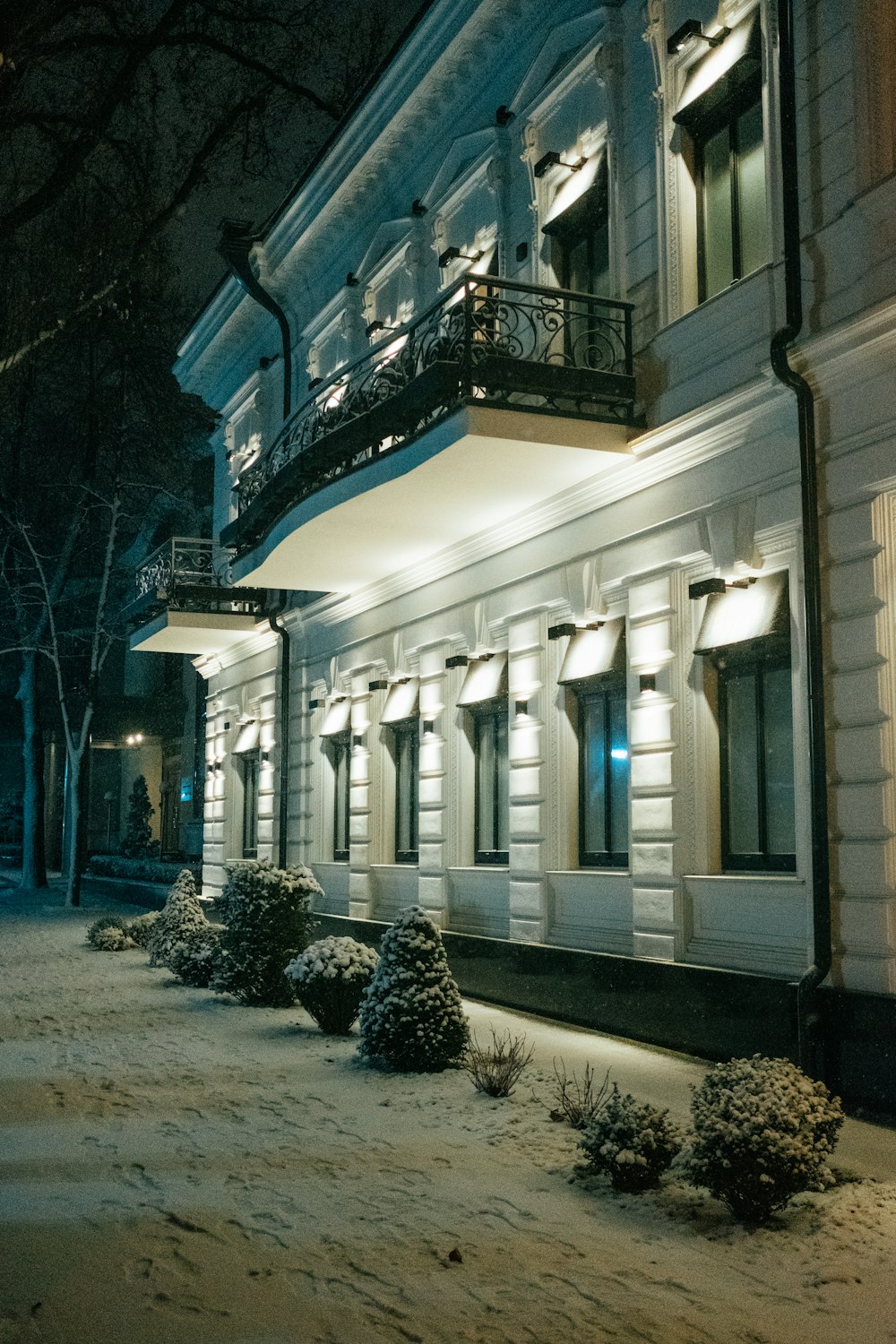 white concrete building with lights turned on during night time