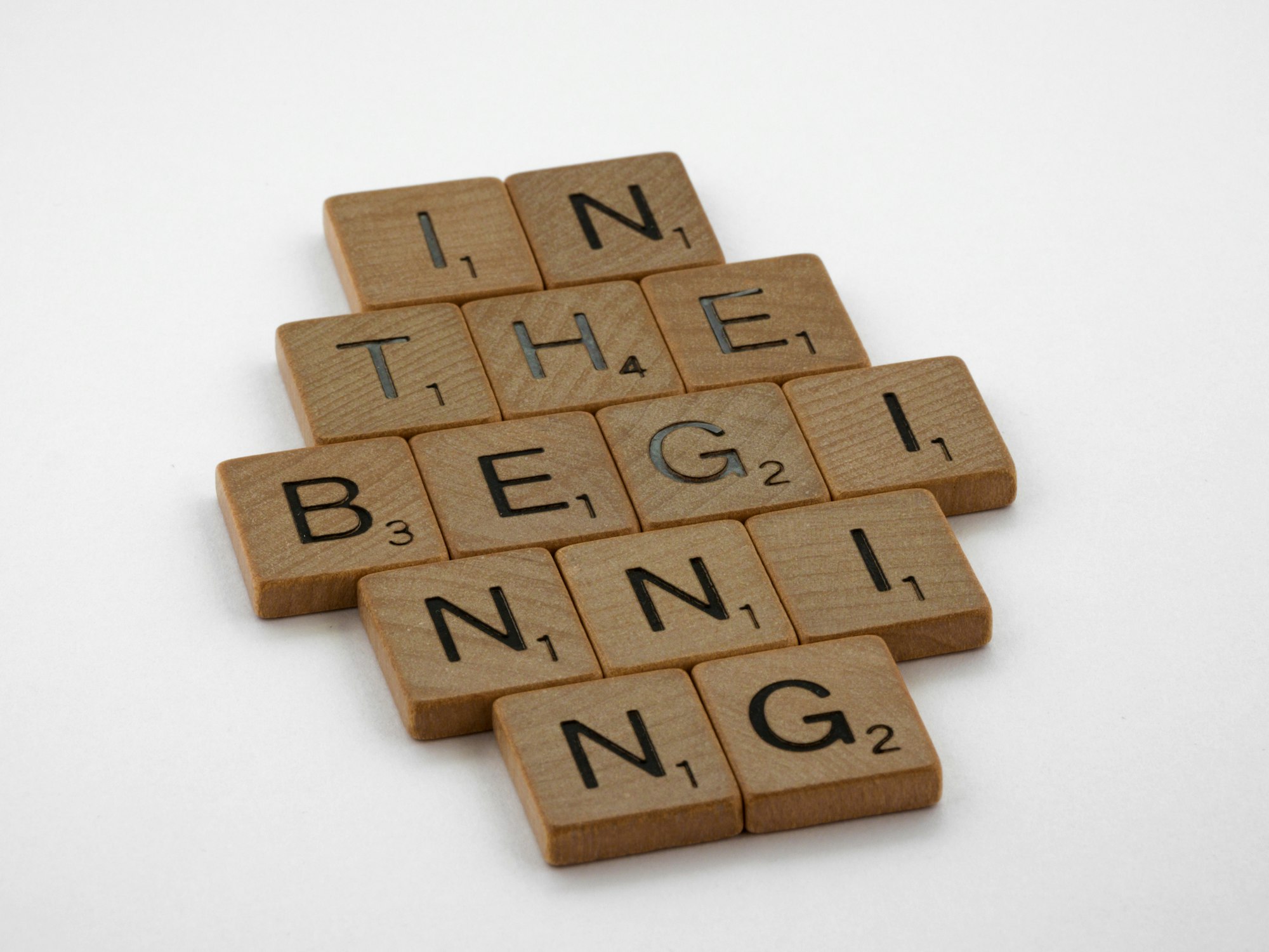 scrabble, scrabble pieces, lettering, letters, wood, scrabble tiles, white background, words, quote, letters, type, typography, design, layout, focus, bokeh, blur, camera, photography, images, image, in the beginning, genesis, genesis chaper 1, bible, creation, begin, start, make a start, book of genesis, 