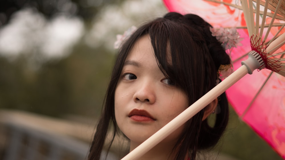 girl in pink lipstick holding pink umbrella