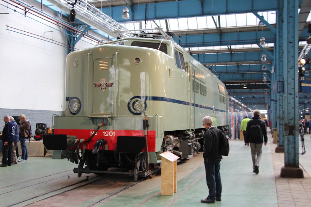 man in black jacket standing beside train