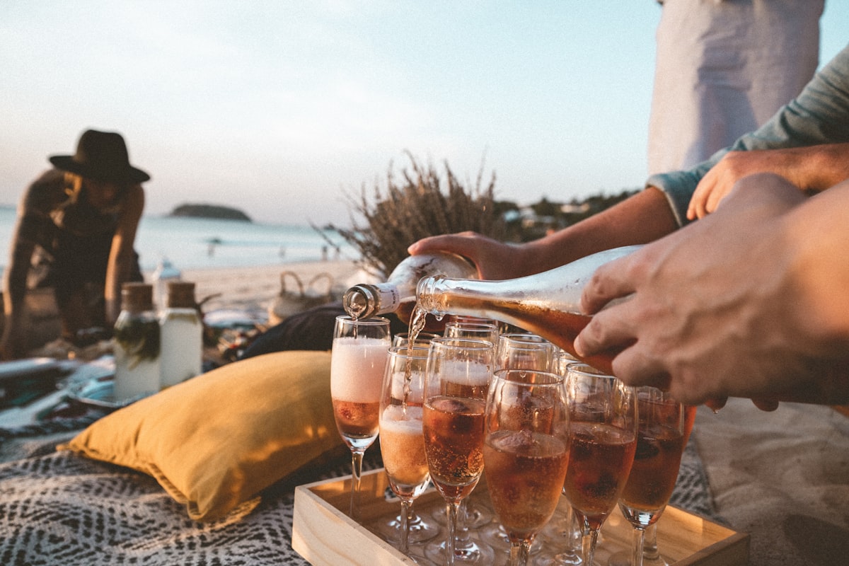 Pouring champagne on the beach