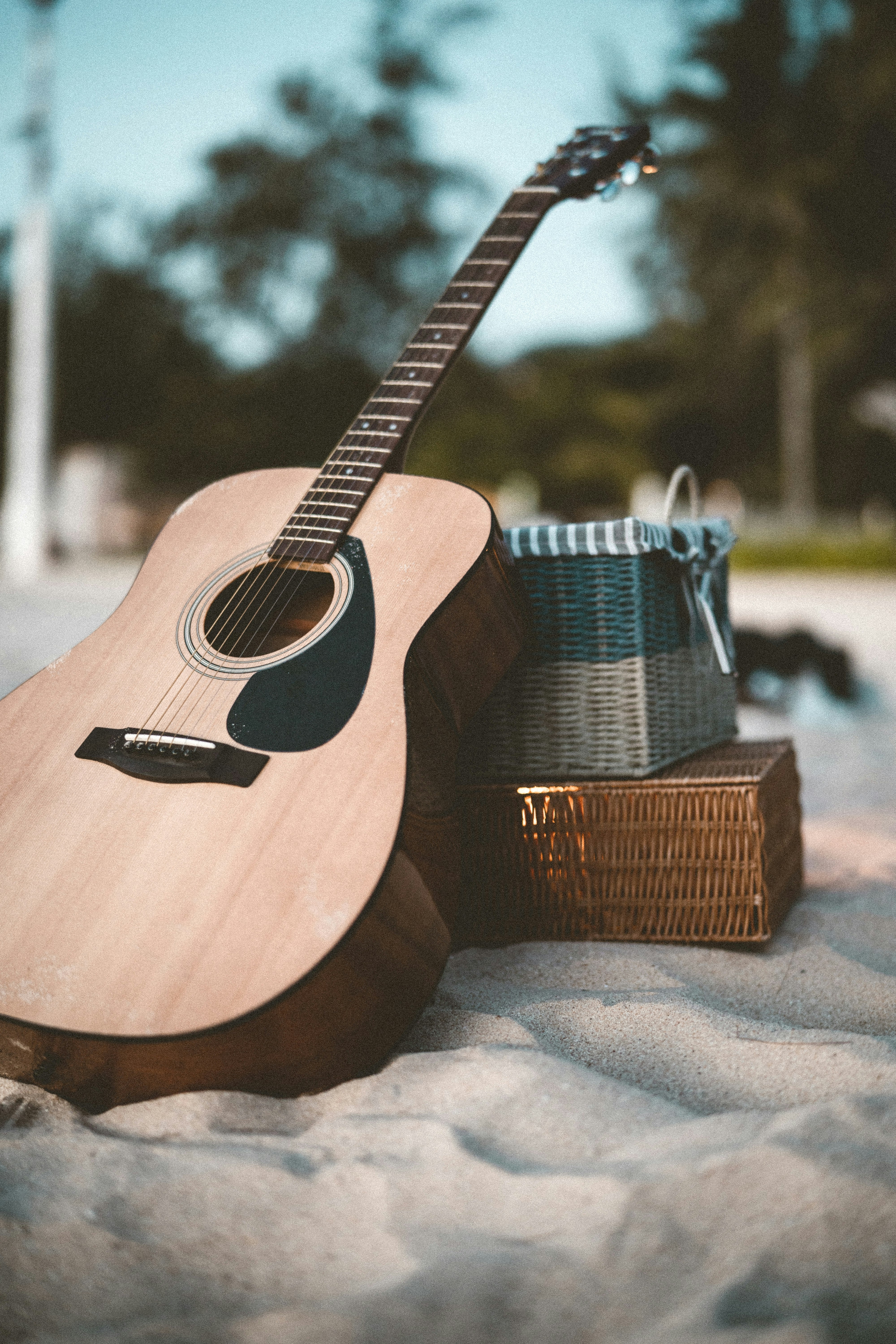 brown acoustic guitar on brown wooden table